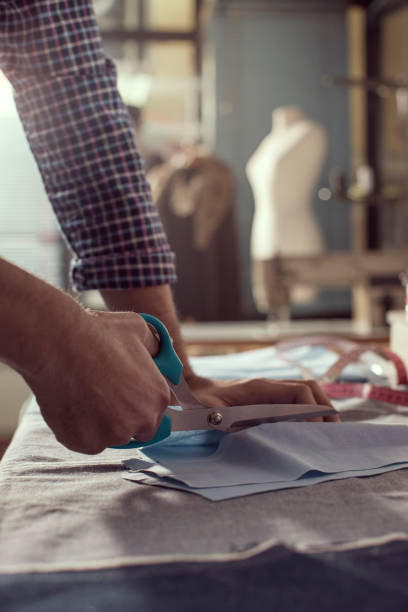 istock Close-up hands of male tailor Cutting Fabric 857976264