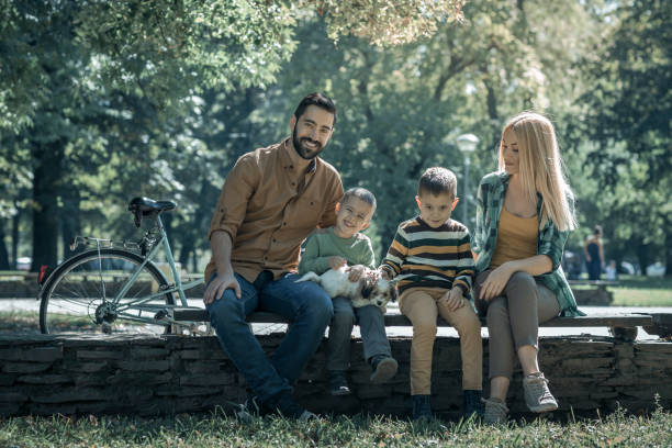 istock Young Family playing with their pet in the park 857978070