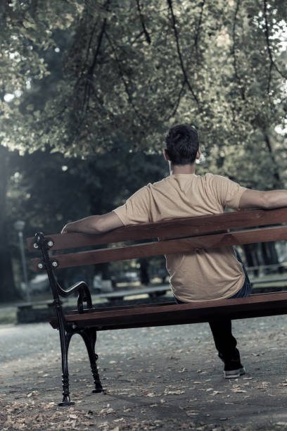 istock Young man waiting for somebody in the park 857978968