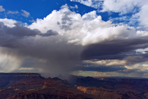 Summer monsoon storm with heavy rain drifts over the Grand Canyon.