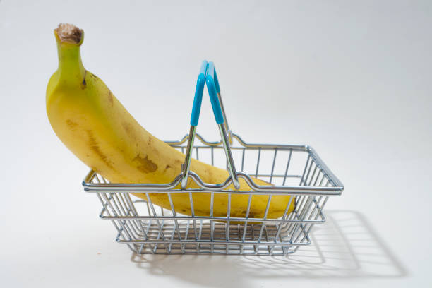 istock Fresh ripe banana and mini shopping basket 857985144
