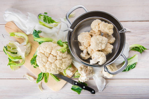 Raw cauliflower on the table of the kitchen stock photo