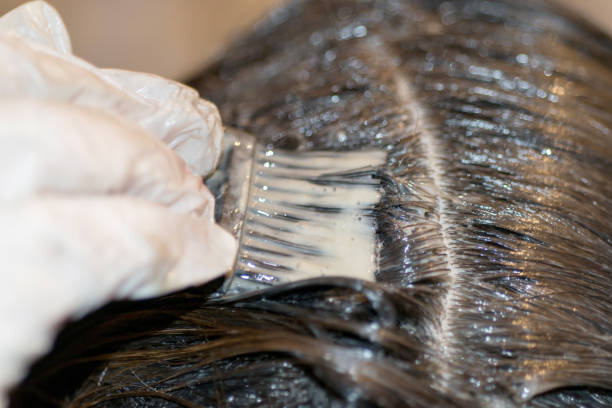 istock Woman dyeing hairs 857989012