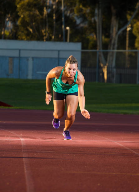 istock Female sprinter / athlete on a tarmac athletics track. 857989630
