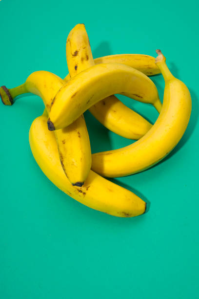 istock Fresh ripe bananas on green background 857989648