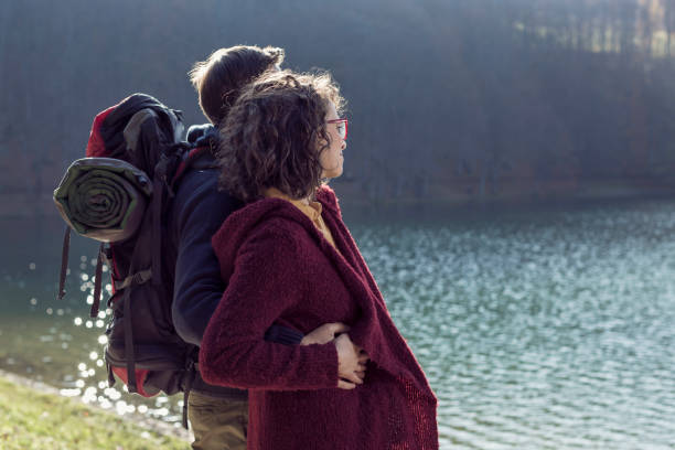 istock Young Couple Hugging by the Lake 857994070