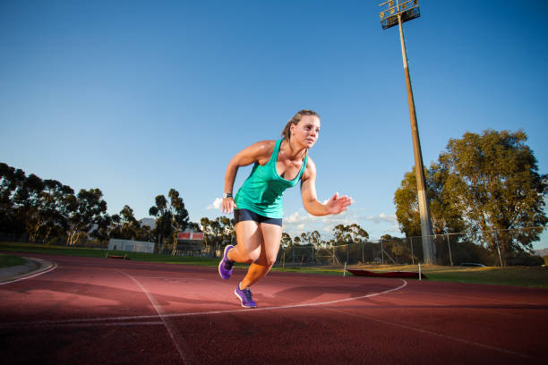 istock Female sprinter / athlete on a tarmac athletics track. 857995796