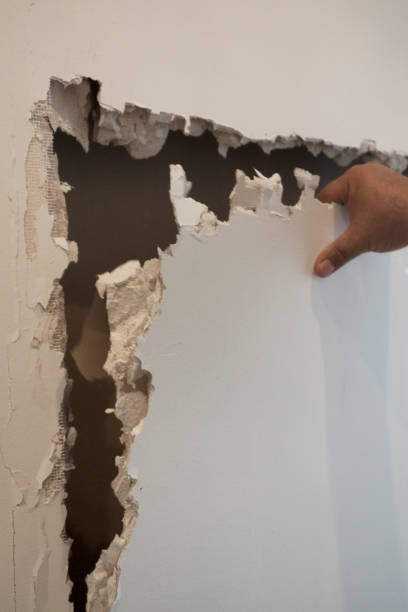 istock Cracked, destruction of a white wall 857996280