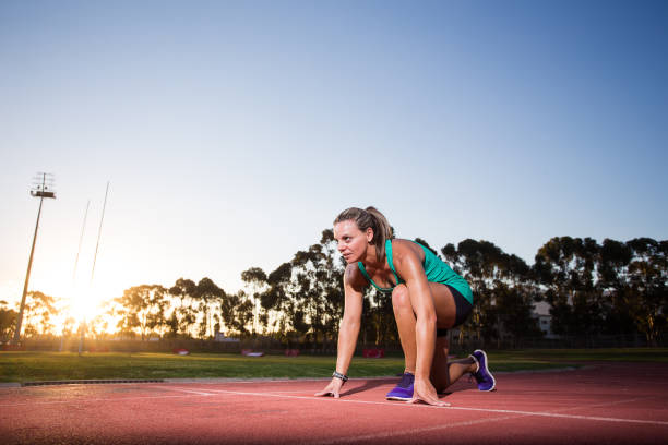 istock Female sprinter / athlete on a tarmac athletics track. 857996640
