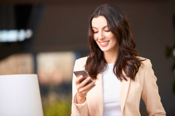 istock Beautiful young woman with cellphone 857999610
