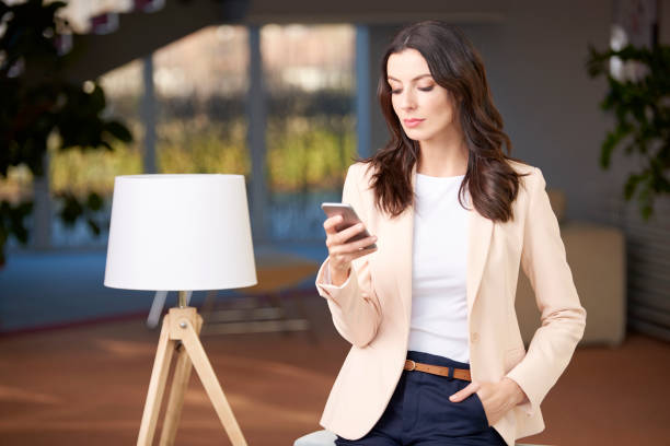 istock Beautiful young woman with cellphone 857999626