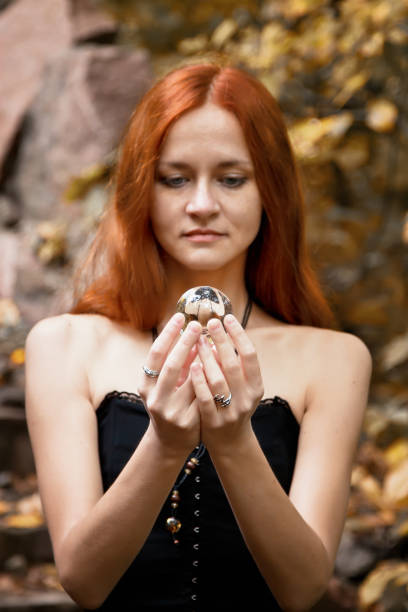 istock Halloween Witch with a magic Pumpkin in a dark forest. 857999796