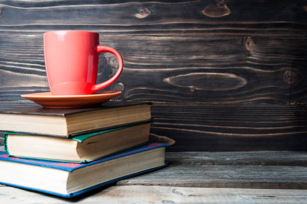istock Hot coffee or tea, cocoa, chocolate cup on book with copy space for text 857999840