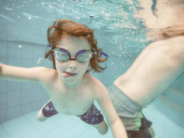 istock Family swimming underwater 858003122