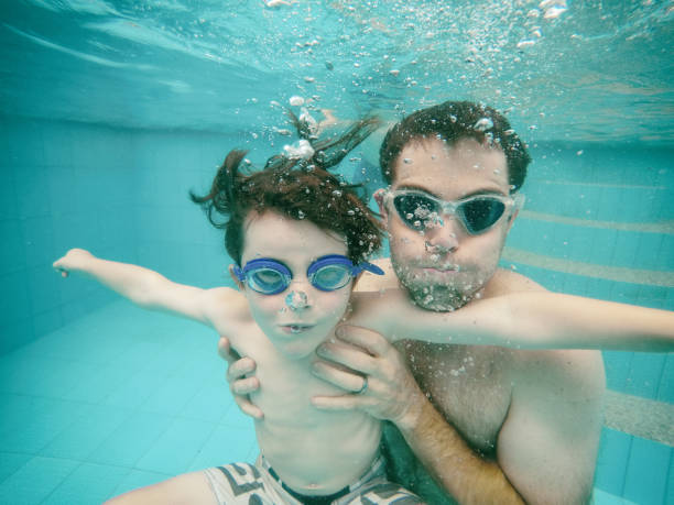 istock Family swimming underwater 858003124