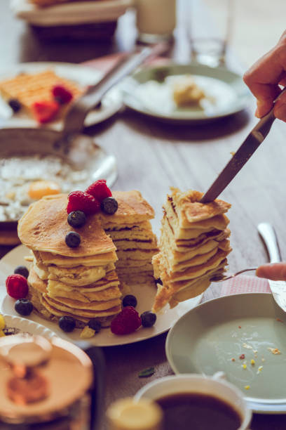 istock Stack of Pancakes with Maple Syrup, Berries and Fresh Coffee 858004840