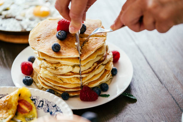 istock Stack of Pancakes with Maple Syrup, Berries and Fresh Coffee 858004866