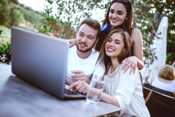 istock Embraced Smiling Friends on Video Conference Outdoors in Coffee Shop 858005652