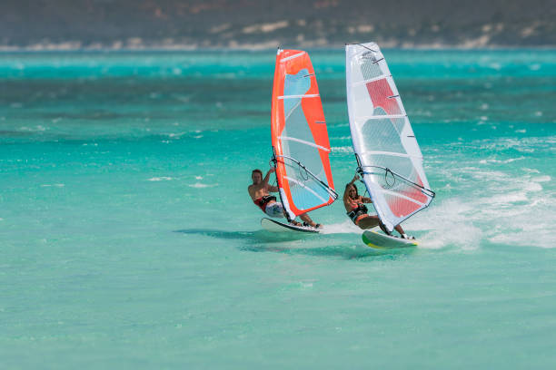 Couple windsurfers Couple windsurfers in the lagoon of Emerald Sea, Antsiranana bay (Diego Suarez), Madagascar. madagascar beach photos stock pictures, royalty-free photos & images
