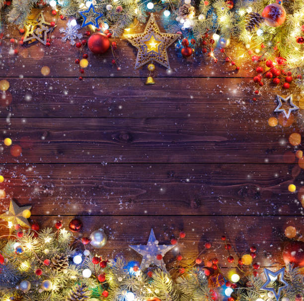 istock Christmas Background - Snowy Fir Branches And Lights On Dark Table 858008608