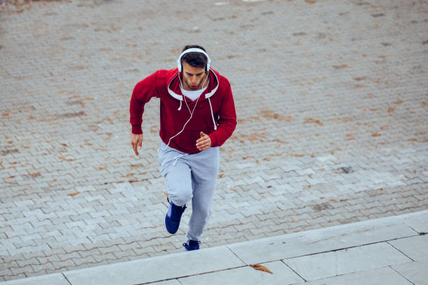 istock Handsome man running up at stairs 858014478