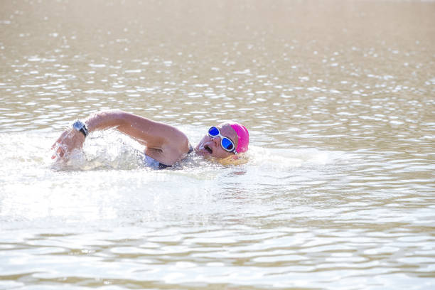 istock Female triathlete training in a dam 858015128