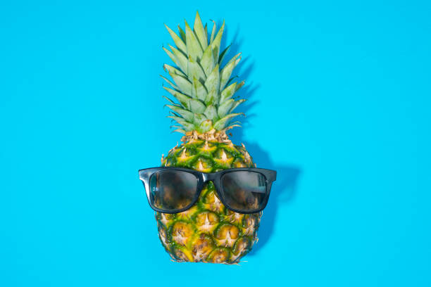 istock Pineapple and sunglasses on blue background 858015142