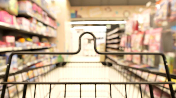 istock Abstract blur empty  shopping cart  in supermarket. 858015278