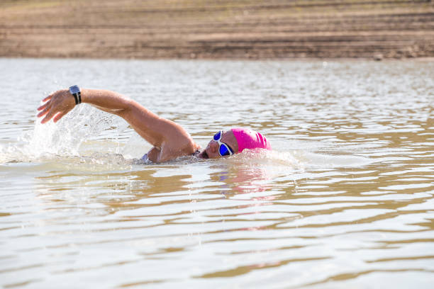 istock Female triathlete training in a dam 858017870