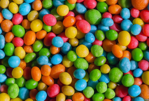 istock Candy confection background with small green, yellow, red colors. Bright texture and round forms of sweets 858018194
