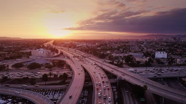 4K drone shot of the 10/110 interchange, aka the Harbor-Santa Monica Interchange, on the western edge of Downtown Los Angeles.
