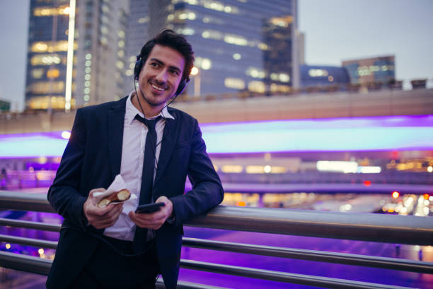 istock Young businessman eating doughnut 858021278