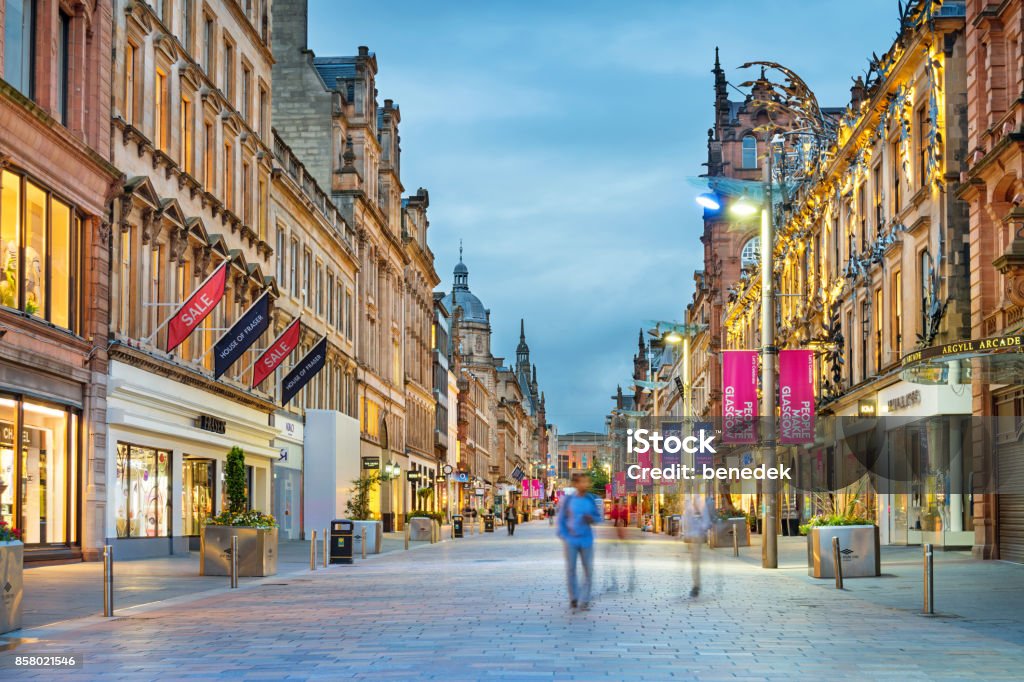 Buchanan Street shopping district in downtown Glasgow Scotland UK Stock photograph of people walking on Buchanan Street in downtown Glasgow, Scotland, UK at twilight. Buchanan Street forms the central stretch of Glasgow's famous shopping district. Glasgow - Scotland Stock Photo