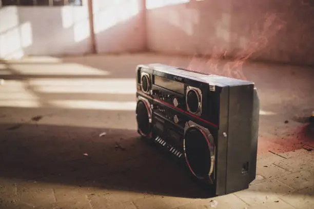 Vintage radio cassette recorder boom box in abandoned empty warehouse