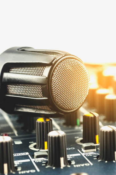istock Close up microphone and audio control room equipment. 858034028