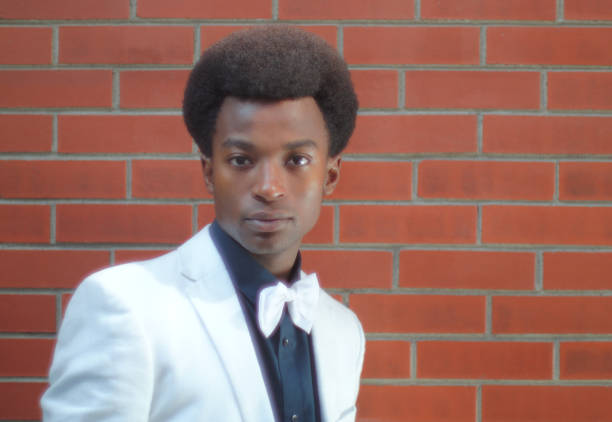 istock young man bow tie black shirt brick wall portrait 858035726