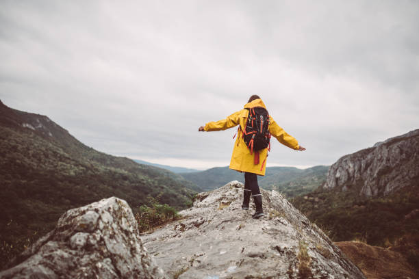 istock Girl walking on mountain rocks 858039412
