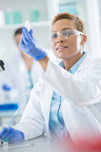 istock Mid adult female lab technician evaluates experiment results 858045774