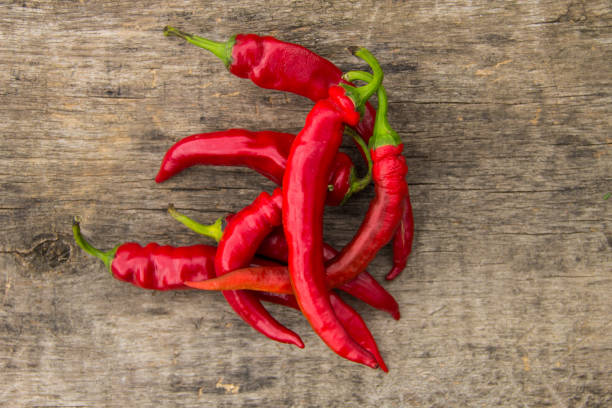istock Red hot chili peppers on wooden table 858049620