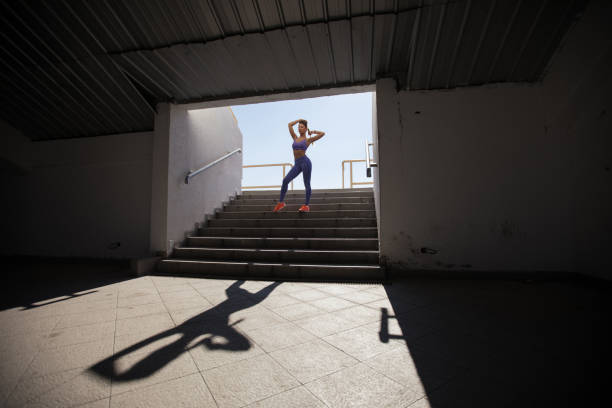 istock Girl standing on the stairs 858056134