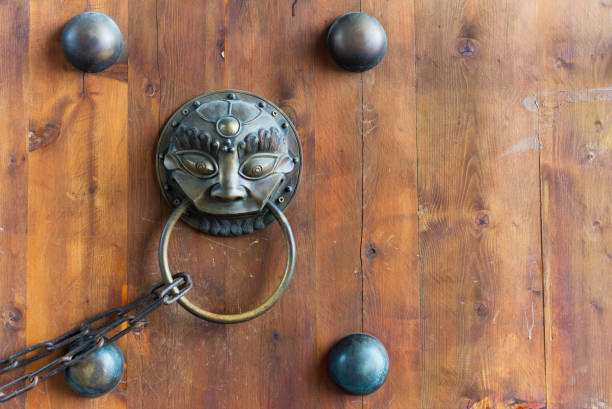 istock Chinese door knocker with a chain on a wooden gate 858064924