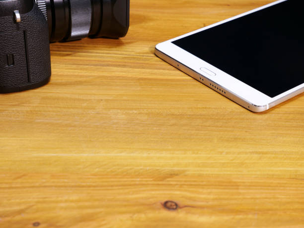 istock high angle view of a tablet and a digital camera 858076462