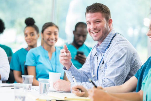 istock Happy doctor speaks on the panel at a medical seminar 858087874