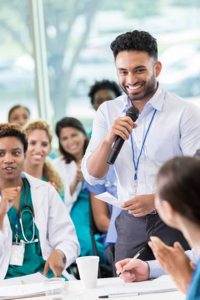 istock Cheerful medical professional facilitates panel discussion 858087938
