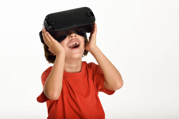 istock Little girl looking in VR glasses and gesturing with his hands. 858096526