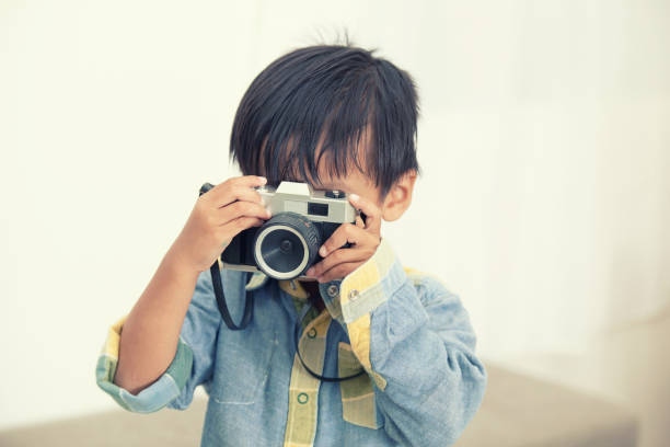 istock Boys holding vintage cameras 858104086