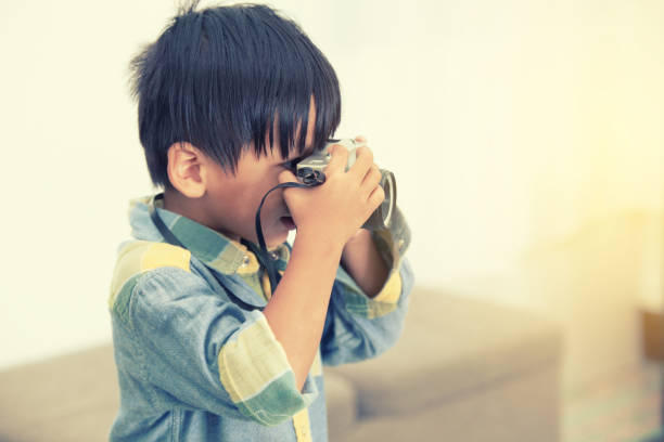 istock Boys holding vintage cameras 858104096