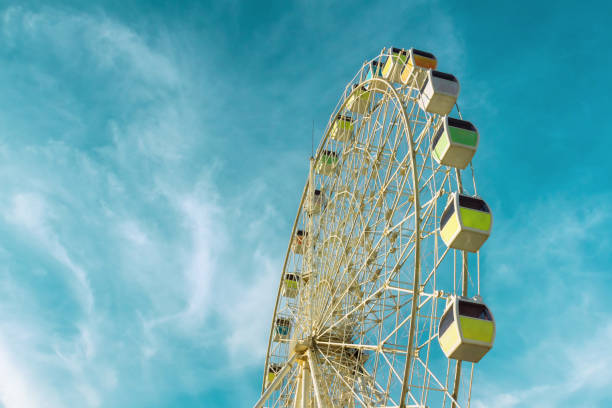 istock Big ferris wheel on blue sky background,vintage style 858106786