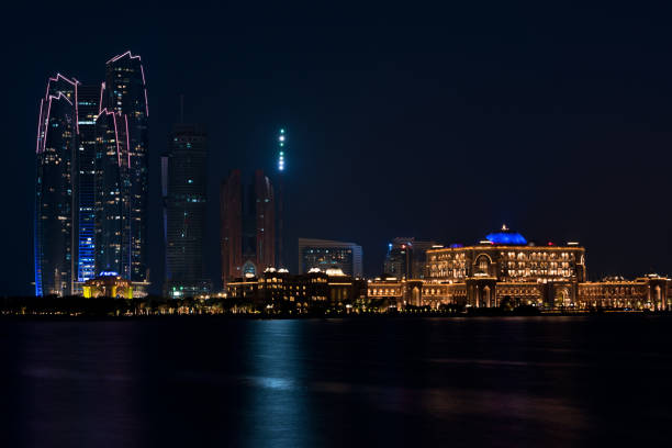 istock Abu Dhabi buildings skyline from the sea at night 858107026