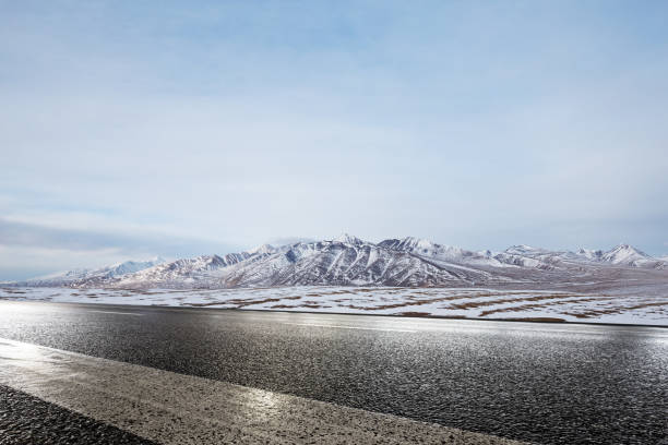 istock empty asphalt road with beautiful snow mountains 858107408